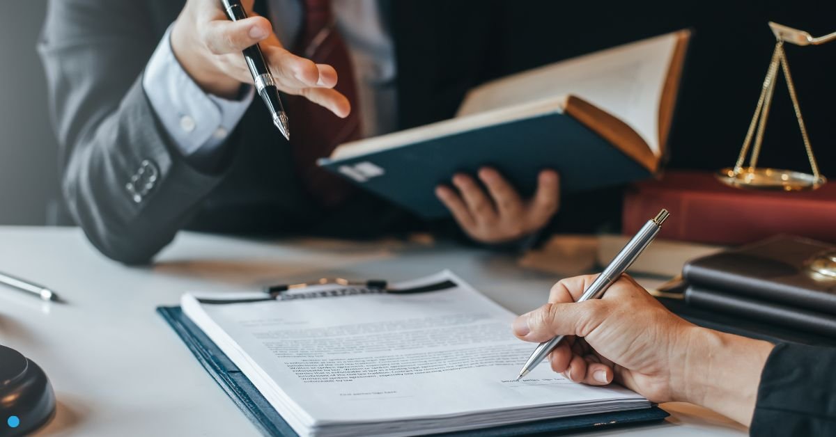 Lawyers reviewing legal documents with scales of justice - The Legal Guide